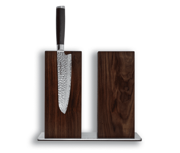 Damascus knife in wooden knife block on white background.