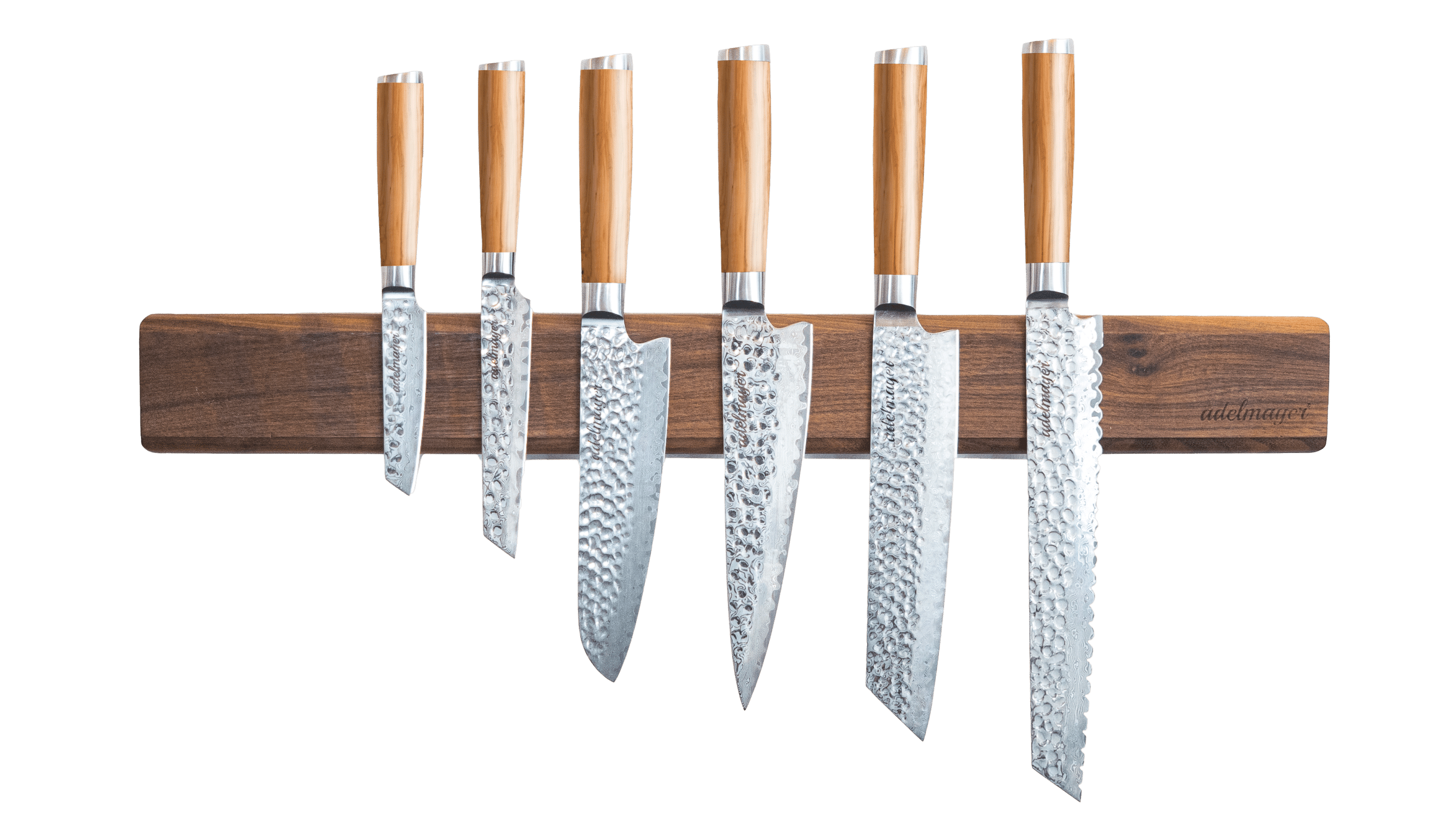 Japanese Damascus knives on magnetic wooden bar.