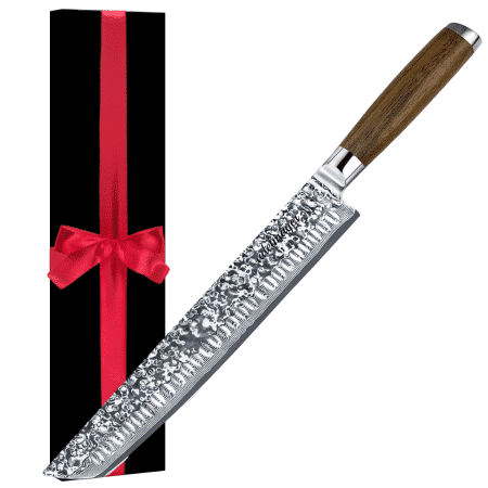 Decorated knife next to gift box with red ribbon.