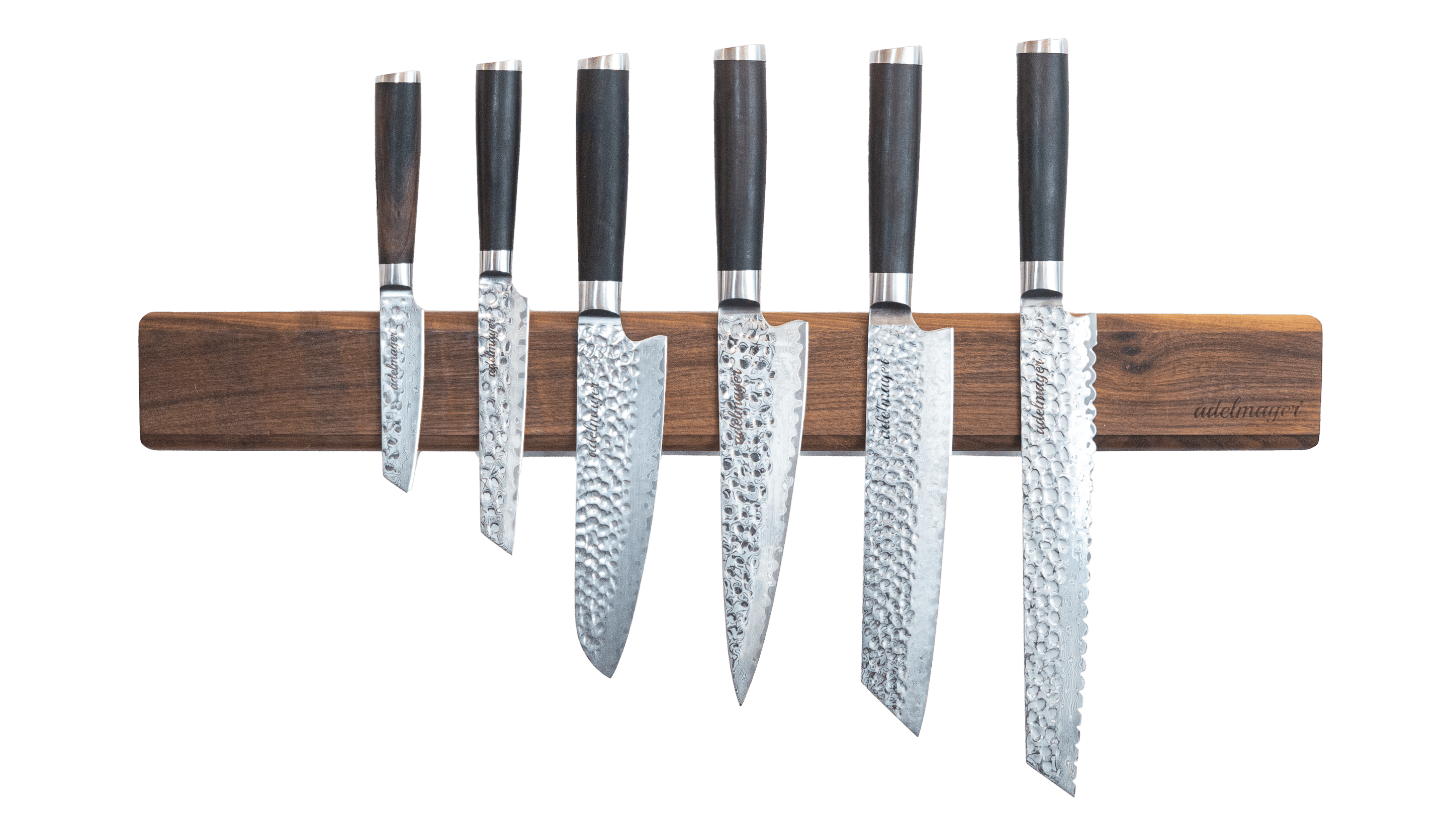 Japanese Damascus knives on magnetic strip.