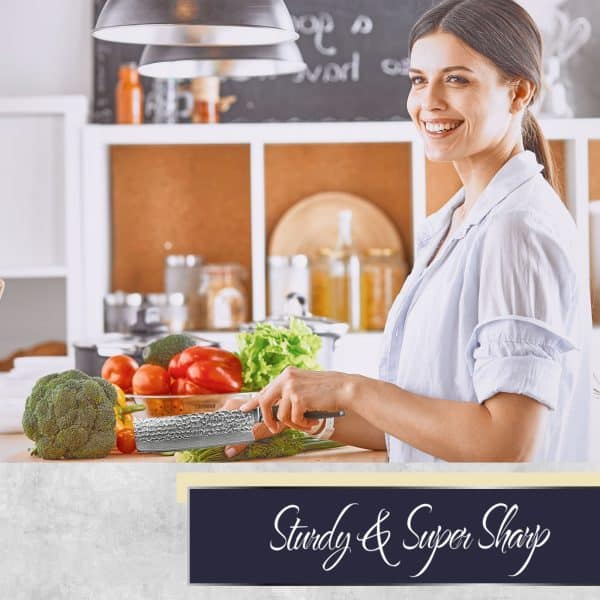 Woman smiling while chopping vegetables in kitchen.